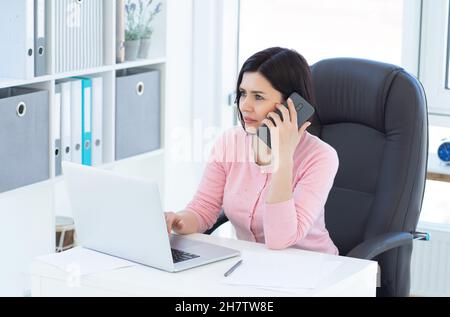 Beautiful business woman using phone Stock Photo