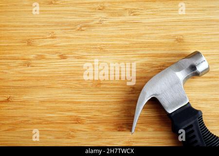 Stubby claw hammer on wooden background with copy space Stock Photo