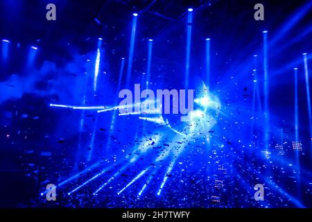 Laser show at generic party night club with bright spotlight on disco ball - Nightlife reopening concept about music and entertainment Stock Photo