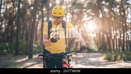 Cyclist checking route on smartphone Stock Photo
