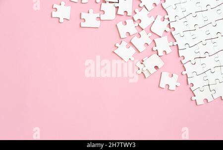 Puzzle pieces on pink background Stock Photo