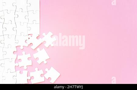 Puzzle pieces on pink background Stock Photo