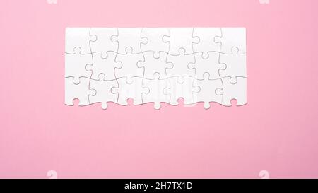 Top view of unfinished white puzzle Stock Photo