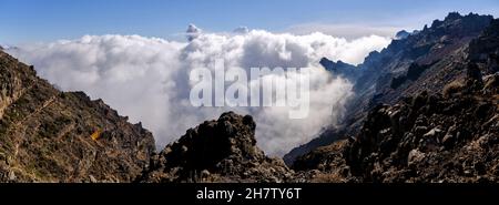 Panoramic sunset over the sea of clouds that covers the mountains of the Caldera de Taburiente in which the ash cloud expelled by the eruption of the Stock Photo