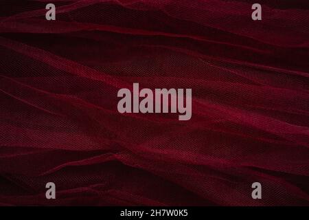 bordo red tulle mesh layers textured background for holiday season beauty marketing Stock Photo