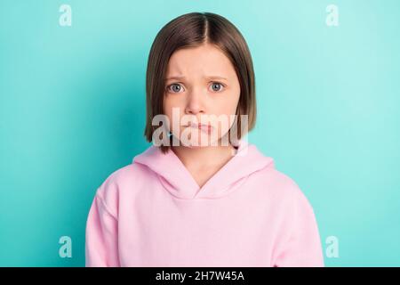 Photo of stressed short hairdo small girl bite lip wear pink sportswear isolated on teal color background Stock Photo