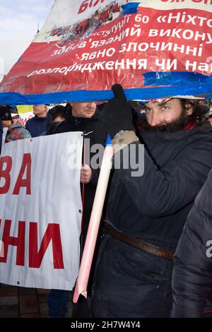 KYIV, UKRAINE - Nov. 24, 2021: Several hundred people protest against coronavirus restrictions and mandatory vaccinations. Stock Photo