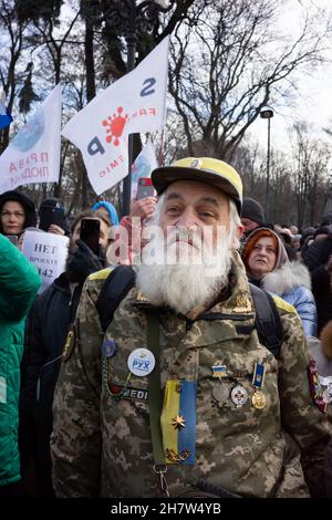 KYIV, UKRAINE - Nov. 24, 2021: Several hundred people protest against coronavirus restrictions and mandatory vaccinations. Stock Photo