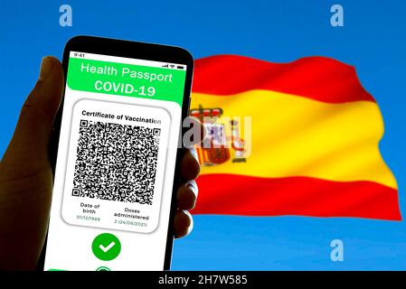 Spain. 24th Nov, 2021. In this illustrative photo a symbolic Covid passport, also called covid certificate of vaccination, is seen on the screen of a mobile phone with the spanish flag in the background in Barcelona, Spain on November 24, 2021. The implementation of the covid19 passport is being discussed in various regions of Spain where infections rate are increasing. (Photo by Davide Bonaldo/Sipa USA) Credit: Sipa USA/Alamy Live News Stock Photo