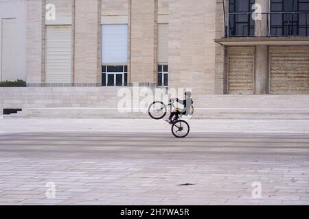 A boy on his bicycle in front of the Lido Casino, Venice, a former casino from the 1930s, today the venue for congresses and filmfestivals.
