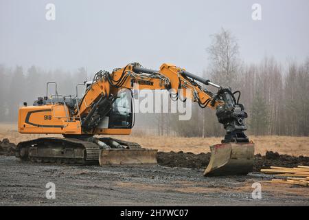 Liebherr 918 crawler excavator on work site on a misty day of spring. Forssa, Finland. April 2, 2017. Stock Photo