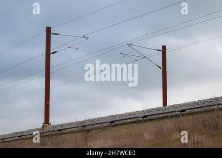 Overhead live electric railway train power supply Stock Photo