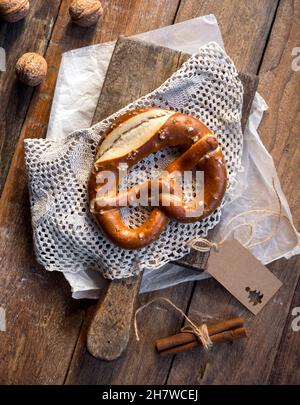 Bretzel (Pretzel) Christmas with cinnamon sticks, festive food on a wooden table for the Christmas holiday Stock Photo