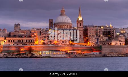 City of Valletta at evening twilight, capital of Malta skyline from the sea Stock Photo