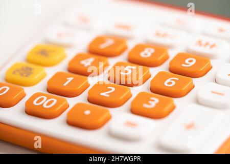 Number pad on orange color calculator for account finance in office. Stock Photo