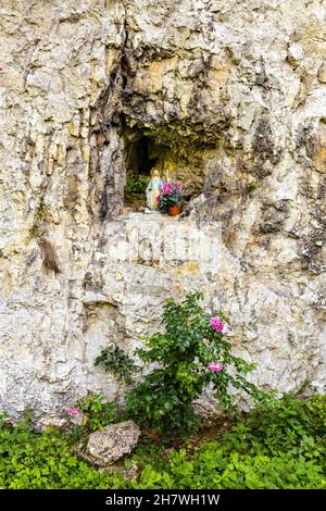 Traditional rock shrine in Jurassic limestone mountain massif in Pradnik creek valley of Cracow-Czestochowa upland in Ojcow in Lesser Poland Stock Photo