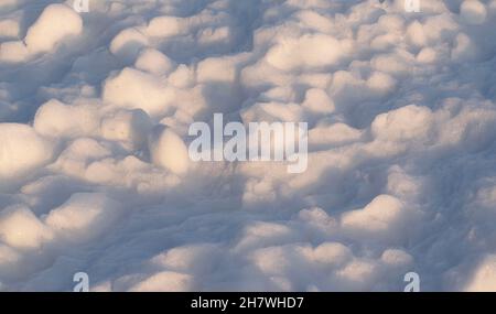 Snow cover on a frosty winter day at sunset with shadows. Horizontal photo, top view. Stock Photo