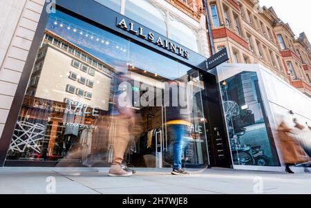 All Saints fashion store, London. Shoppers walking by the entrance to the high street fashion store in London's affluent Kensington shopping district. Stock Photo