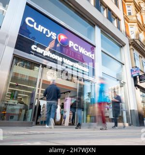 Currys PC World shop, Oxford Street, London. Abstract blur of shoppers passing the high street electrical store on London's busy shopping district. Stock Photo