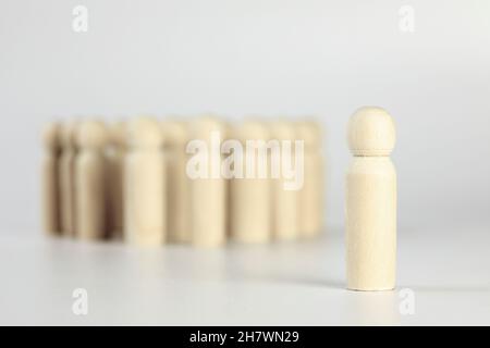 Group of people, one person standing out of the crowd, different or left out concept isolated on white background Stock Photo