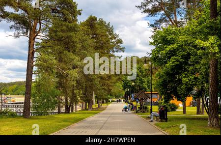 Augustow, Poland - June 1, 2021: Touristic boulevard and public beach at Necko lake shore in Masuria lake district resort town of Augustow in Podlaski Stock Photo