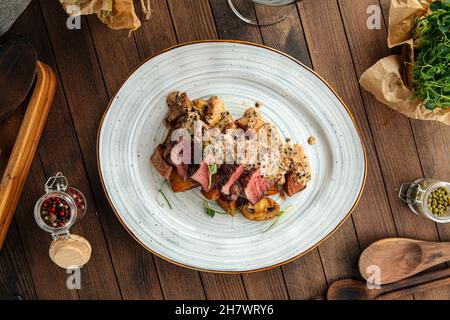 Beef medallions dish with potatoes and mushrooms Stock Photo