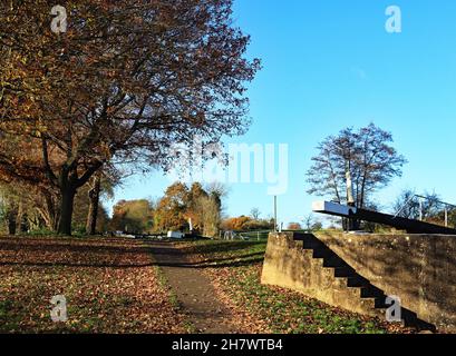 The steps from the lock landing to the towpath are creating strong shadows in the autumn sunshine at Hatton Locks on the Grand Union canal. Stock Photo