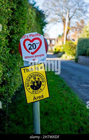 Street furniture warning of a Neighbourhood Watch area and promoting a 20 mph speed limit in East Hanney, Wantage, Oxfordshire, UK. Stock Photo
