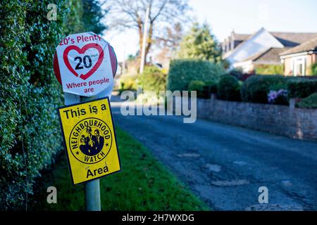 Street furniture warning of a Neighbourhood Watch area and promoting a 20 mph speed limit in East Hanney, Wantage, Oxfordshire, UK. Stock Photo