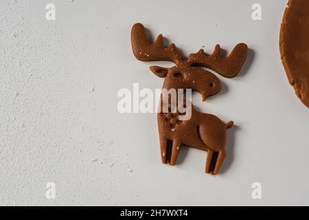 Beautiful deer carved on raw ginger dough Concept of Preparation for Christmas and New Year. Home baked gingerbread, close-up, selective focus Stock Photo