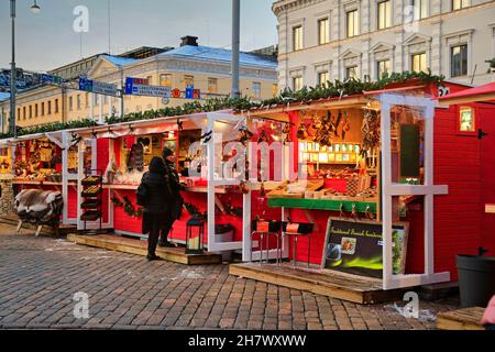 Vendors and visitors at Manta Christmas market, Mantan joulumarkkinat, at Havis Amanda square by Kauppatori, Helsinki, Finland. December 10, 2019. Stock Photo