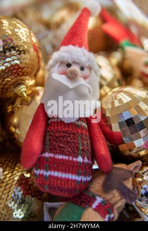fabric decorative santa claus with golden Shimmering balls on background. Christmas time. vertical Stock Photo