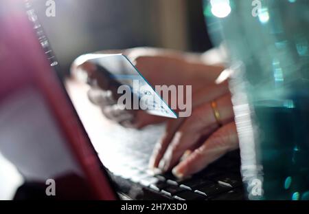 senior woman making internet online card purchase using laptop computer Stock Photo