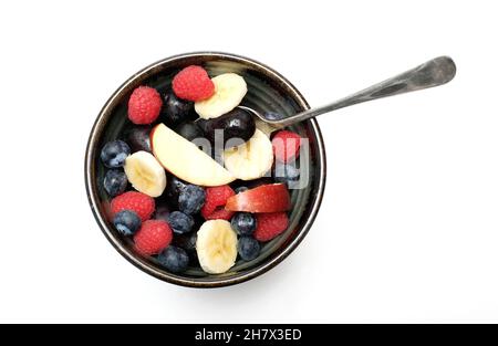rustic bowl full of fresh fruit on white background Stock Photo