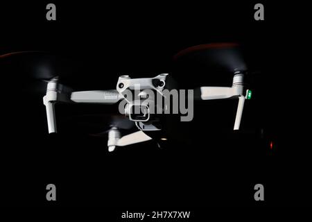 Nürtingen, Germany - June 26, 2021: Drone dji air 2s from front. Isolated on black. Illuminated with 1 flash at night. Side view. Stock Photo