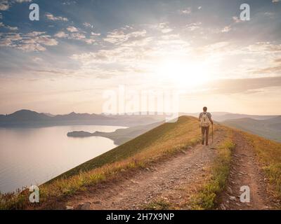 Young Man Travels Alone Walking On Trail And Enjoying On View Of 