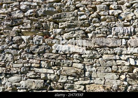 old stone wall made by hand Stock Photo