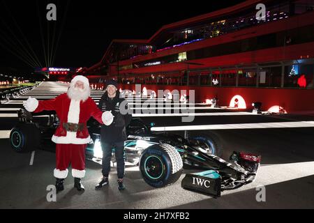 Anthony Davidson (GBR) Drives the Formula One Mercedes-AMG F1 W10 EQ Power+ around the Silverstone Lap of Lights whilst Father Christmas watches on Stock Photo