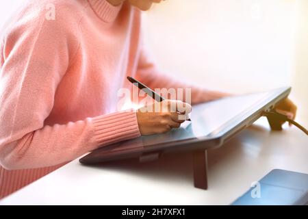 Woman graphic designer or photo editor working on digital graphic tablet Stock Photo