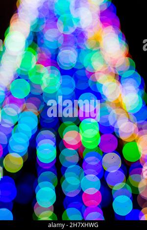 Colored blurred lights, defocused background. New Year Christmas background with multicolored blurred lights. Stock Photo
