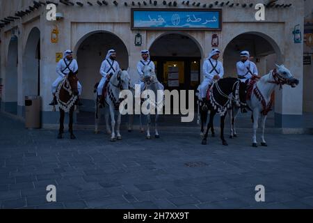 Souq Waqif Doha, Qatar daylight view showing police station with traditional guards riding horses Stock Photo