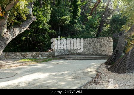a stone wall in the woods, mini stage Stock Photo