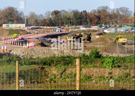 Aylesbury, UK. 25th November, 2021. HS2 construction work gathers pace on former farmland compulsorily purchased by HS2 in Aylesbury. A haul road is being built at the site off the Oxford Road and huge dumper trucks regularly cross one of the few public footpaths that HS2 haven't closed off. Although the Eastern Leg of the HS2 High Speed Rail has been cancelled by Boris Johnson, HS2 Ltd are continuing with their construction of Phase 1 of the HS2 High Speed Rail from London to Birmingham which is destroying swathes of the Chilterns, an Area of Outstanding Natural Beauty. Credit: Maureen McLean Stock Photo