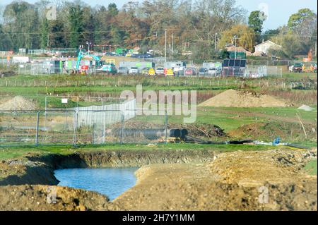 Aylesbury, UK. 25th November, 2021. HS2 construction work gathers pace on former farmland compulsorily purchased by HS2 in Aylesbury. A haul road is being built at the site off the Oxford Road and huge dumper trucks regularly cross one of the few public footpaths that HS2 haven't closed off. Although the Eastern Leg of the HS2 High Speed Rail has been cancelled by Boris Johnson, HS2 Ltd are continuing with their construction of Phase 1 of the HS2 High Speed Rail from London to Birmingham which is destroying swathes of the Chilterns, an Area of Outstanding Natural Beauty. Credit: Maureen McLean Stock Photo