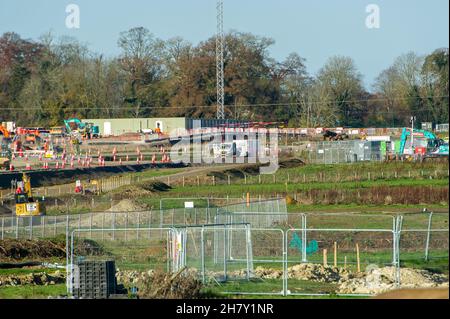 Aylesbury, UK. 25th November, 2021. HS2 construction work gathers pace on former farmland compulsorily purchased by HS2 in Aylesbury. A haul road is being built at the site off the Oxford Road and huge dumper trucks regularly cross one of the few public footpaths that HS2 haven't closed off. Although the Eastern Leg of the HS2 High Speed Rail has been cancelled by Boris Johnson, HS2 Ltd are continuing with their construction of Phase 1 of the HS2 High Speed Rail from London to Birmingham which is destroying swathes of the Chilterns, an Area of Outstanding Natural Beauty. Credit: Maureen McLean Stock Photo