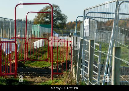 Aylesbury, UK. 25th November, 2021. HS2 construction work gathers pace on former farmland compulsorily purchased by HS2 in Aylesbury. A haul road is being built at the site off the Oxford Road and huge dumper trucks regularly cross one of the few public footpaths that HS2 haven't closed off. Although the Eastern Leg of the HS2 High Speed Rail has been cancelled by Boris Johnson, HS2 Ltd are continuing with their construction of Phase 1 of the HS2 High Speed Rail from London to Birmingham which is destroying swathes of the Chilterns, an Area of Outstanding Natural Beauty. Credit: Maureen McLean Stock Photo