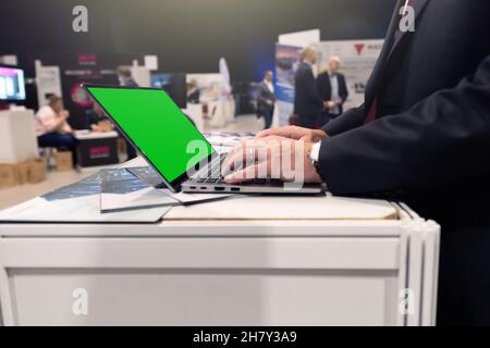 Focused businessman using laptop in conference room meeting Stock Photo