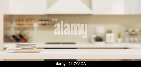 Copy space on kitchen table with a set of plate, napkin and chopping board over blurred modern kitchen room in the background. 3d rendering, 3d illust Stock Photo