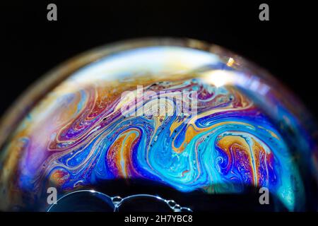Abstract pattern, multicolored chaotic texture inside of the soap bubble, closeup Stock Photo