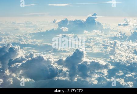 View over the clouds at high altitude with clusters of Cumulus Nimbus Stock Photo